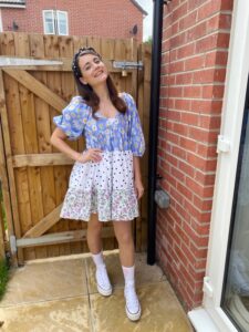 Amy, our influencer, sporting a floral dress and Converse trainers for a concert look.