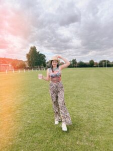 Amy, our stylish influencer, rocking a cowboy and animal print trousers in a field at recent festival.
